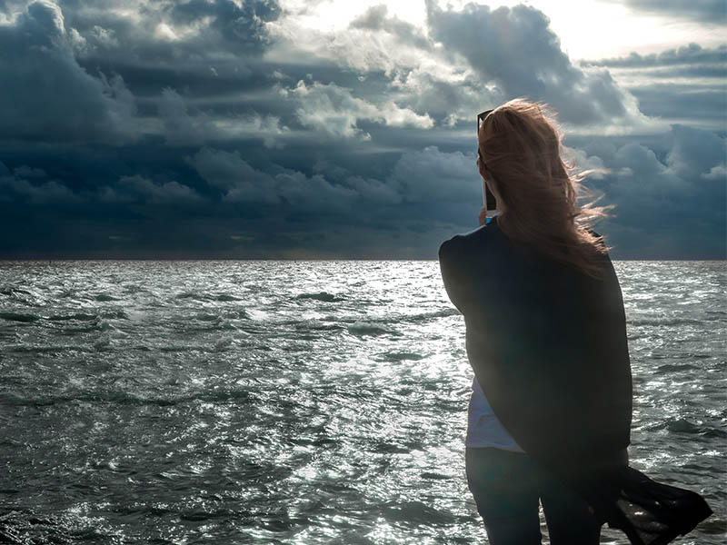 Woman looking out to North Sea horizon.